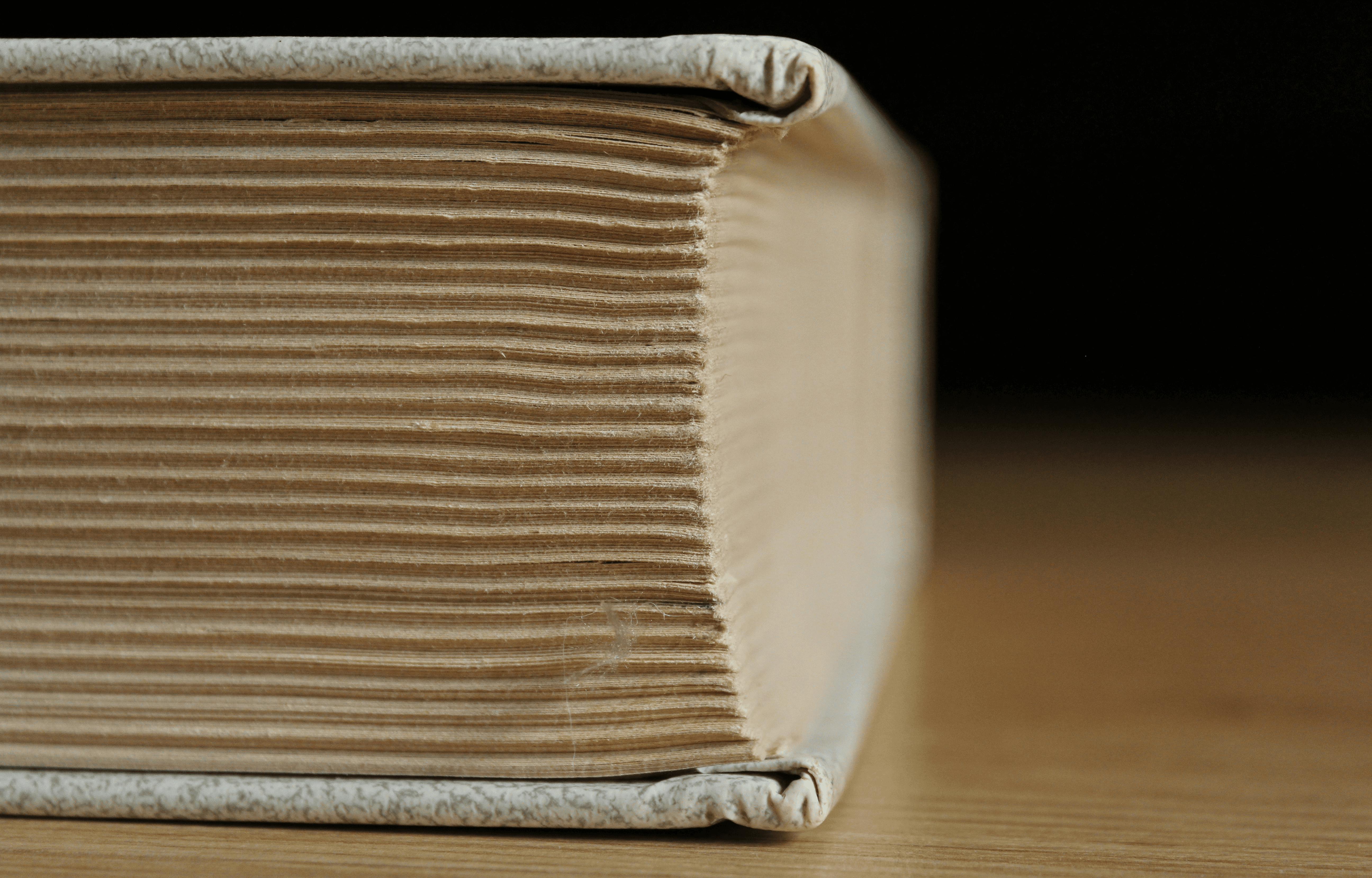 A close-up of an old hardcover book with yellowed pages.