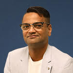 A professional profile picture of a man