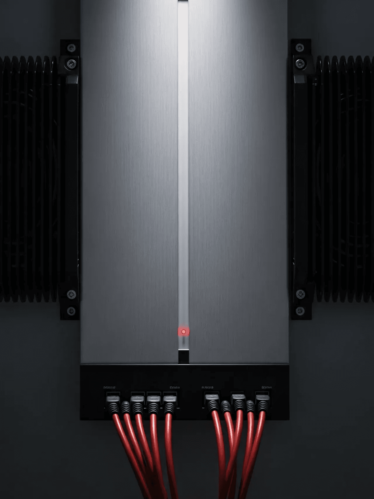 Front view of industrial module with red cables and cooling fins