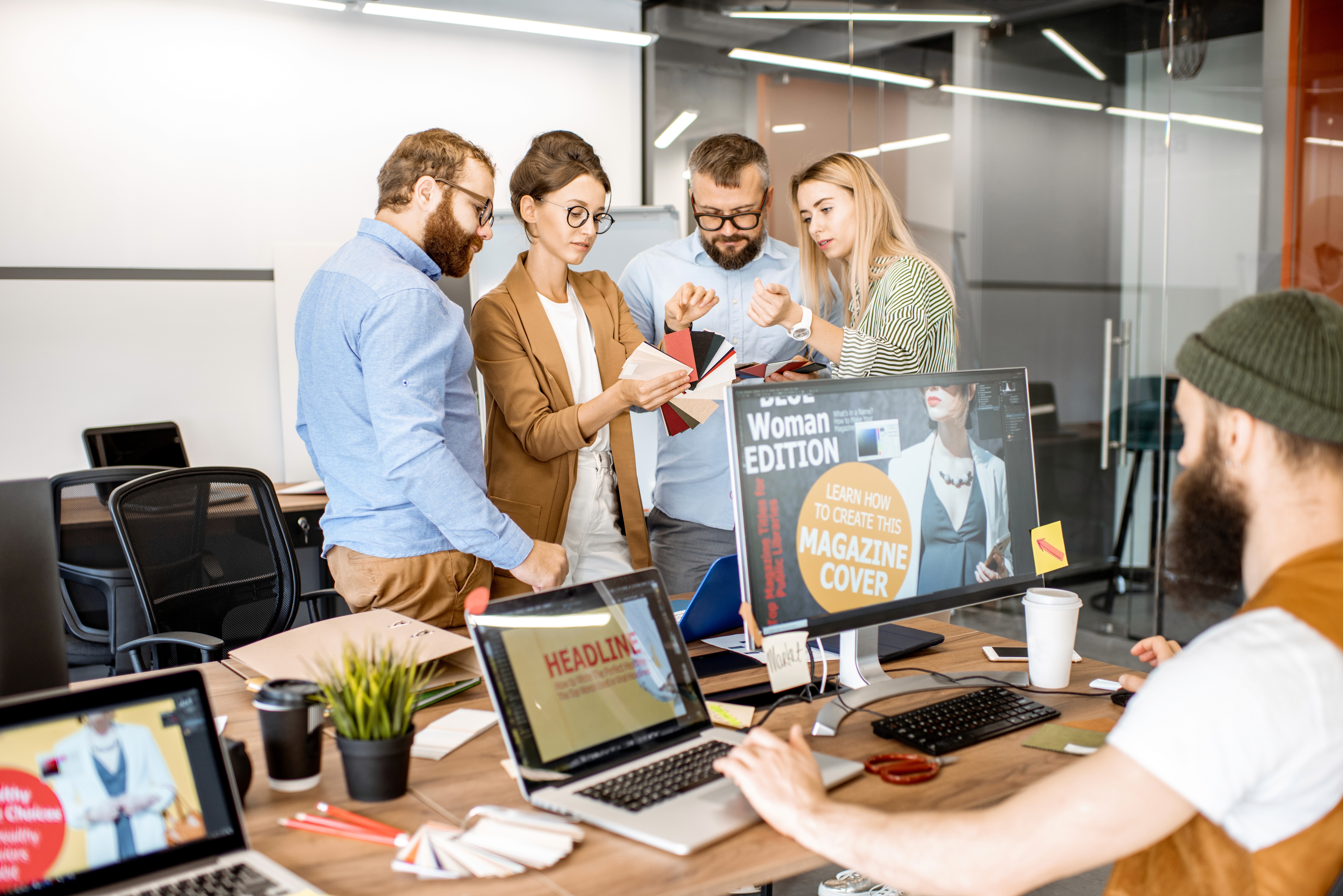 Business team brainstorming a marketing strategy on a large planning sheet covered in sticky notes, representing the complexity of building a marketing plan for a service business