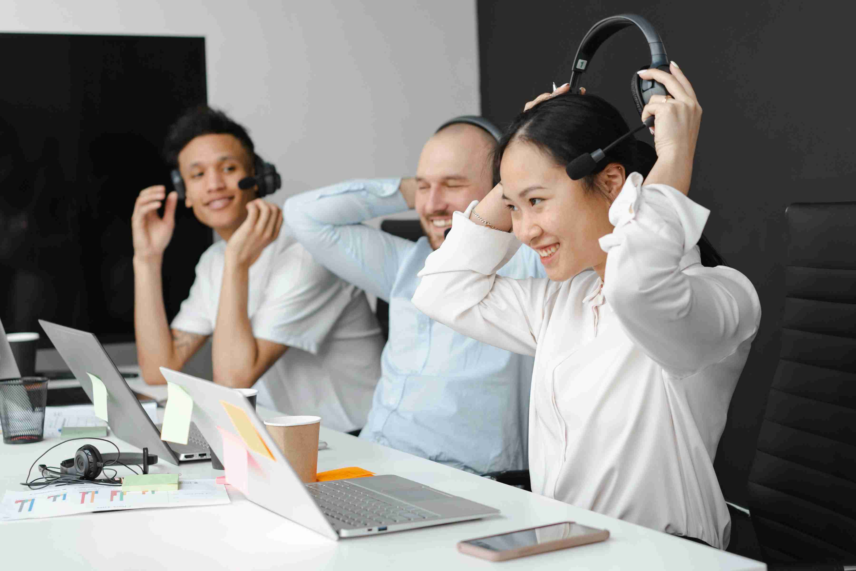 three people in an office who just finished a live webinar