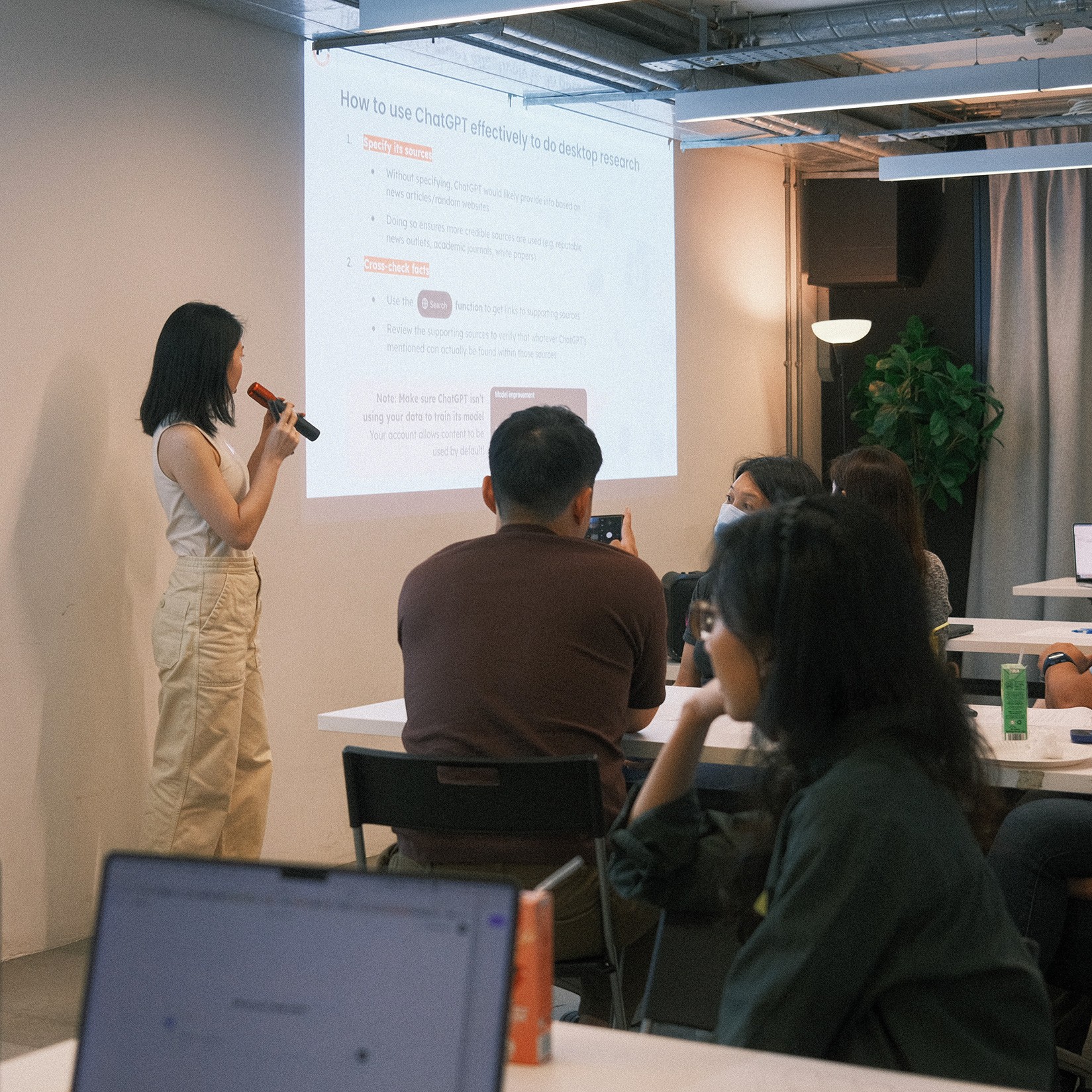 Participants looking at the projected screen while Lynn is presenting.