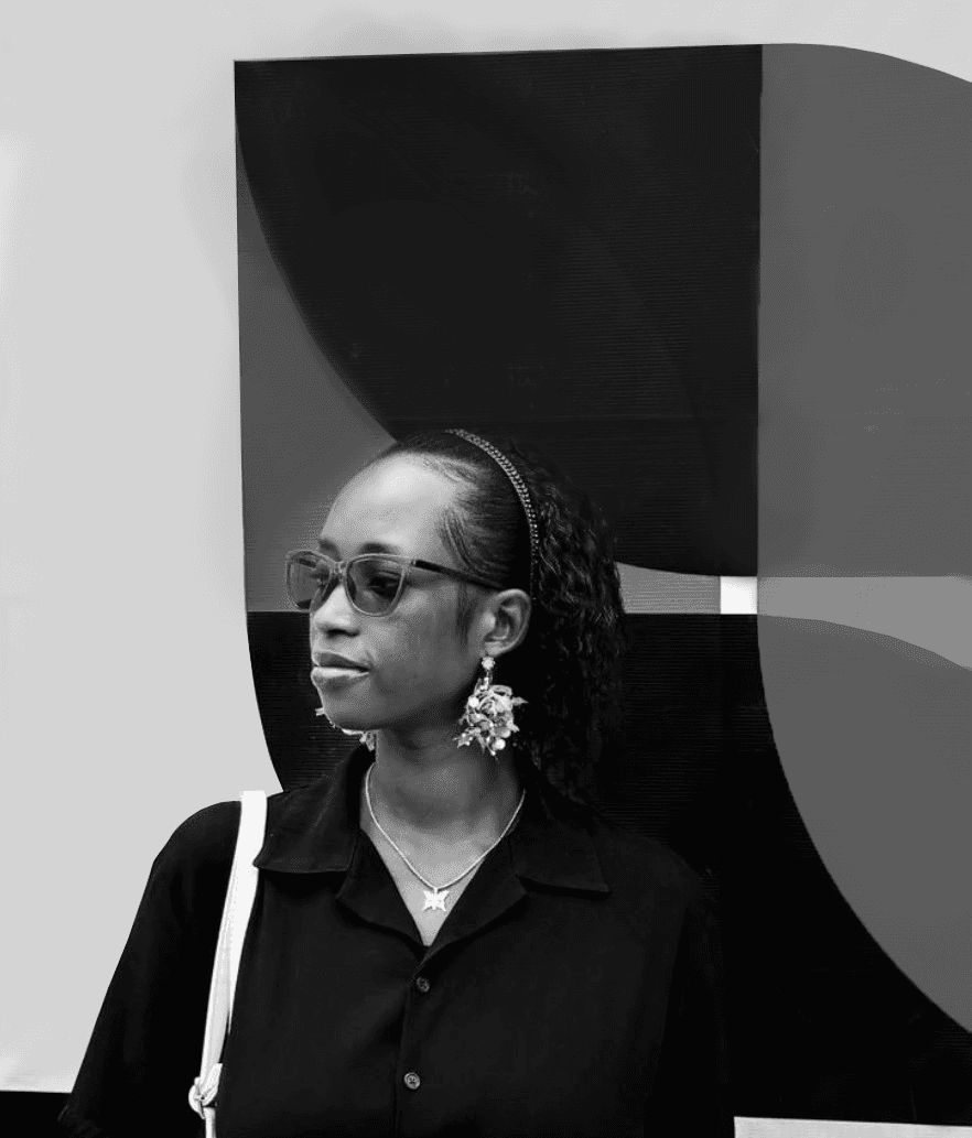 A person with glasses and earrings stands against an abstract geometric background, looking thoughtfully to the side.