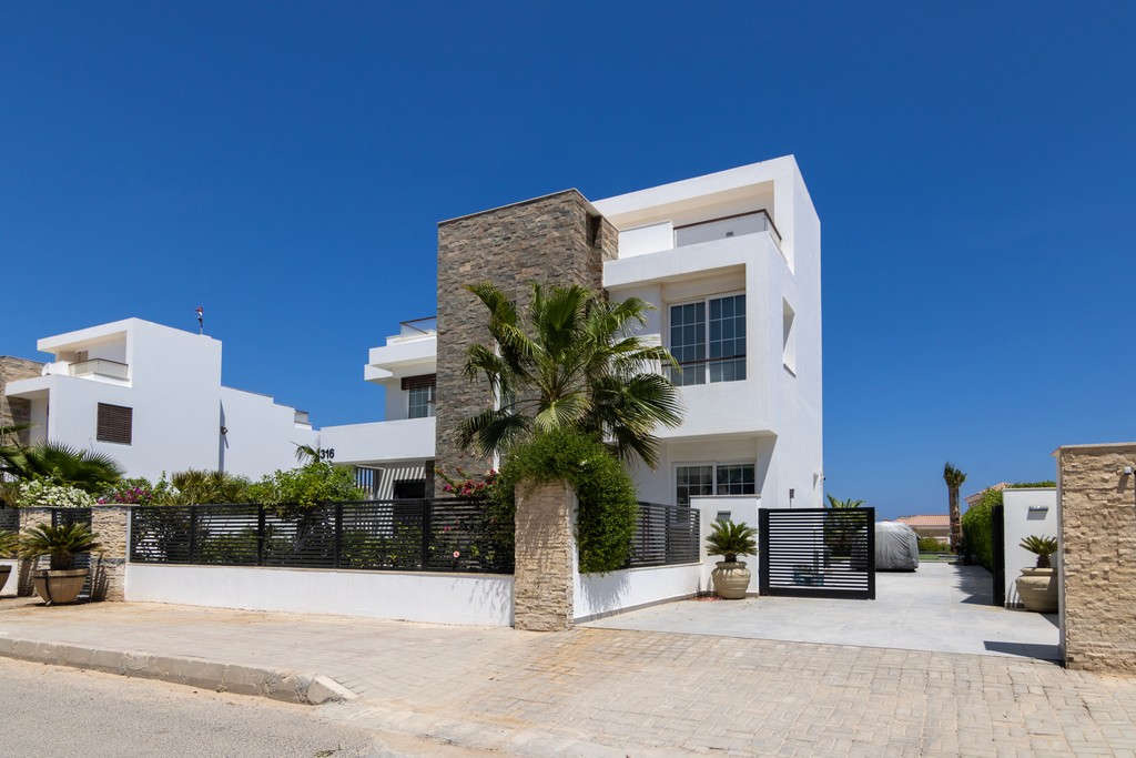 brown wooden house with green grass field