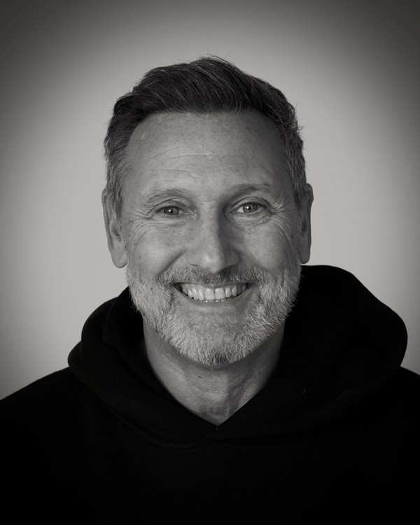 headshot of male in dark background