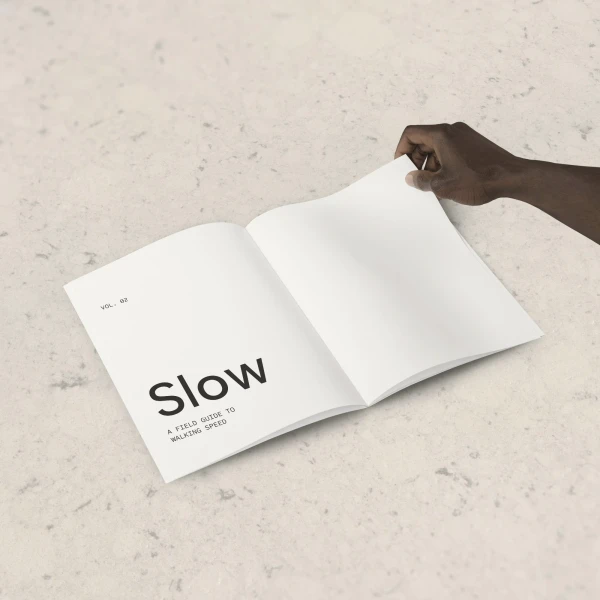 Hand opening a printed field guide