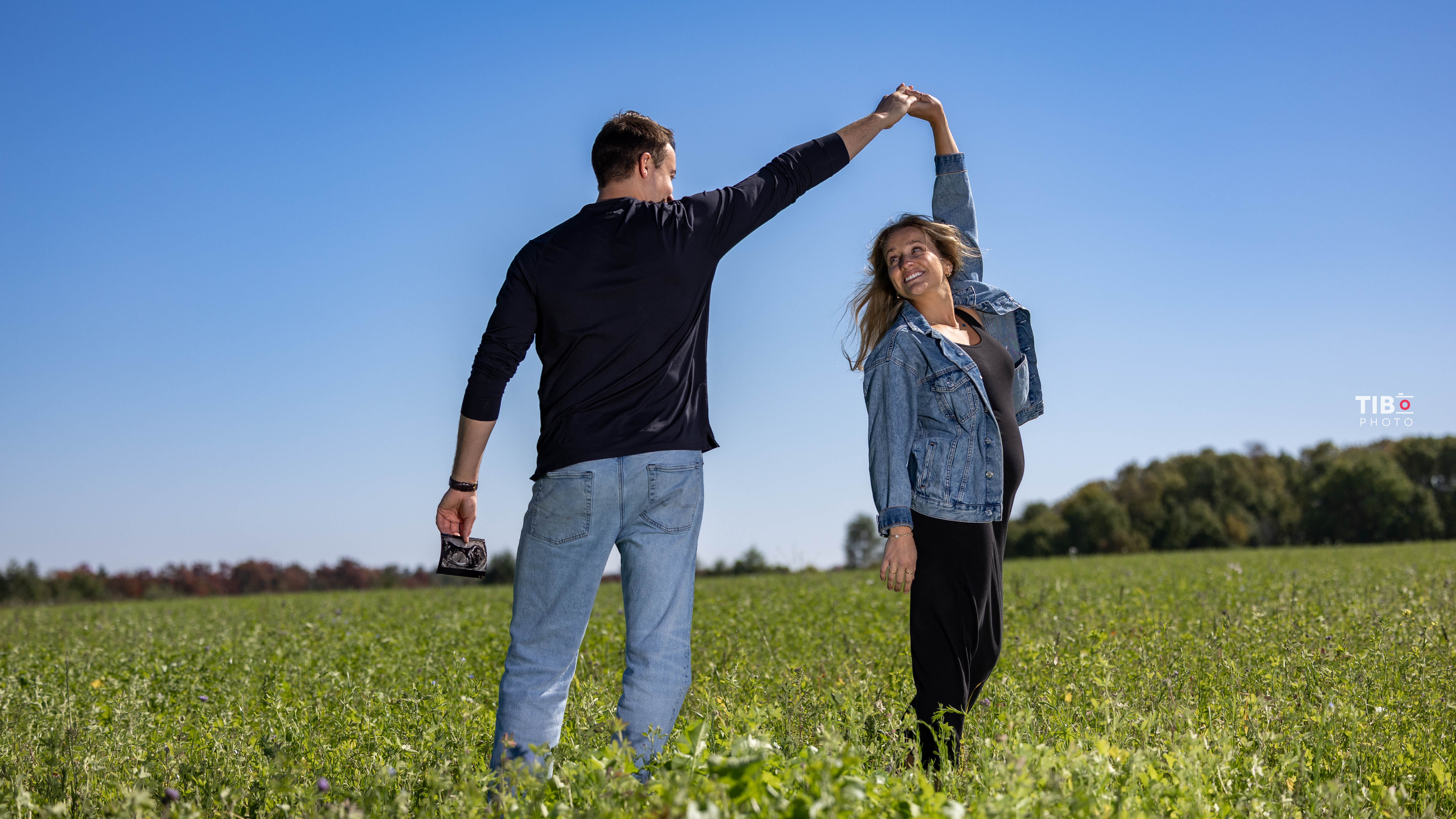 a woman holding a red flower
