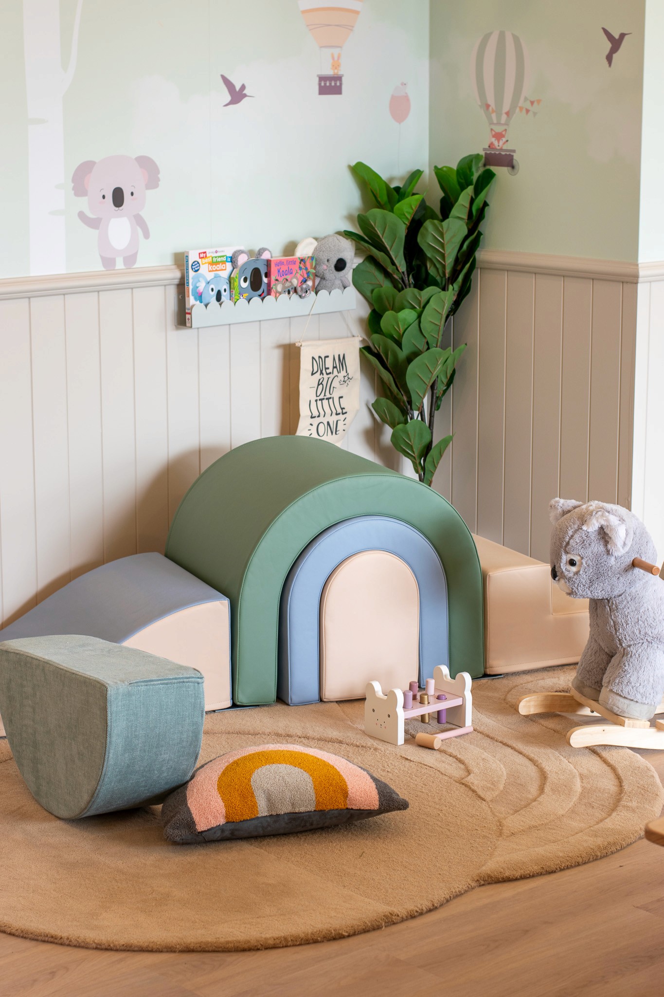 Close-up of a dark green leaf showing its textured surface and central vein against a muted background.