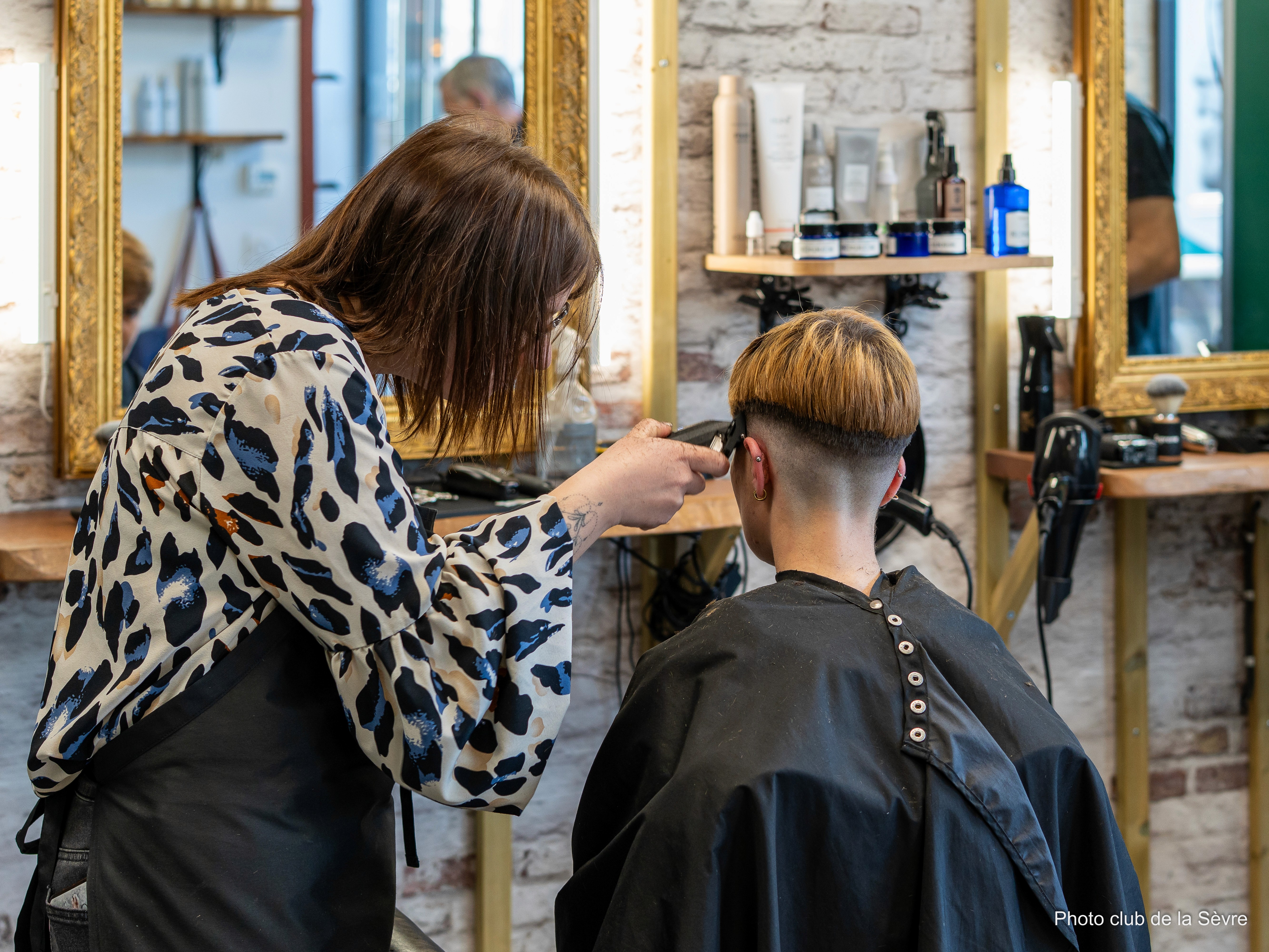 man in black shirt holding smartphone