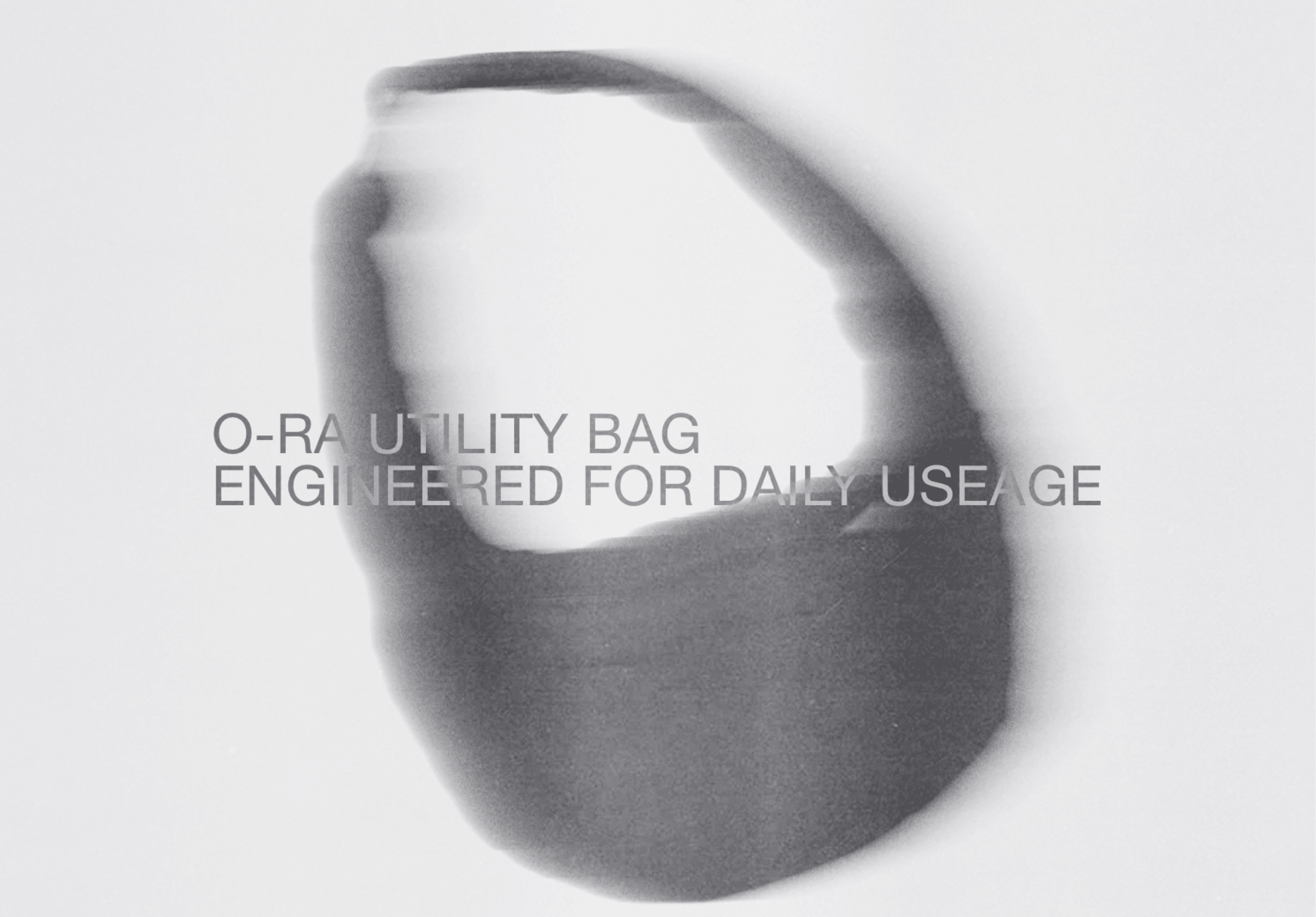 O-RA Utility Bag shown in soft grayscale with product labeling text overlaid — World Building