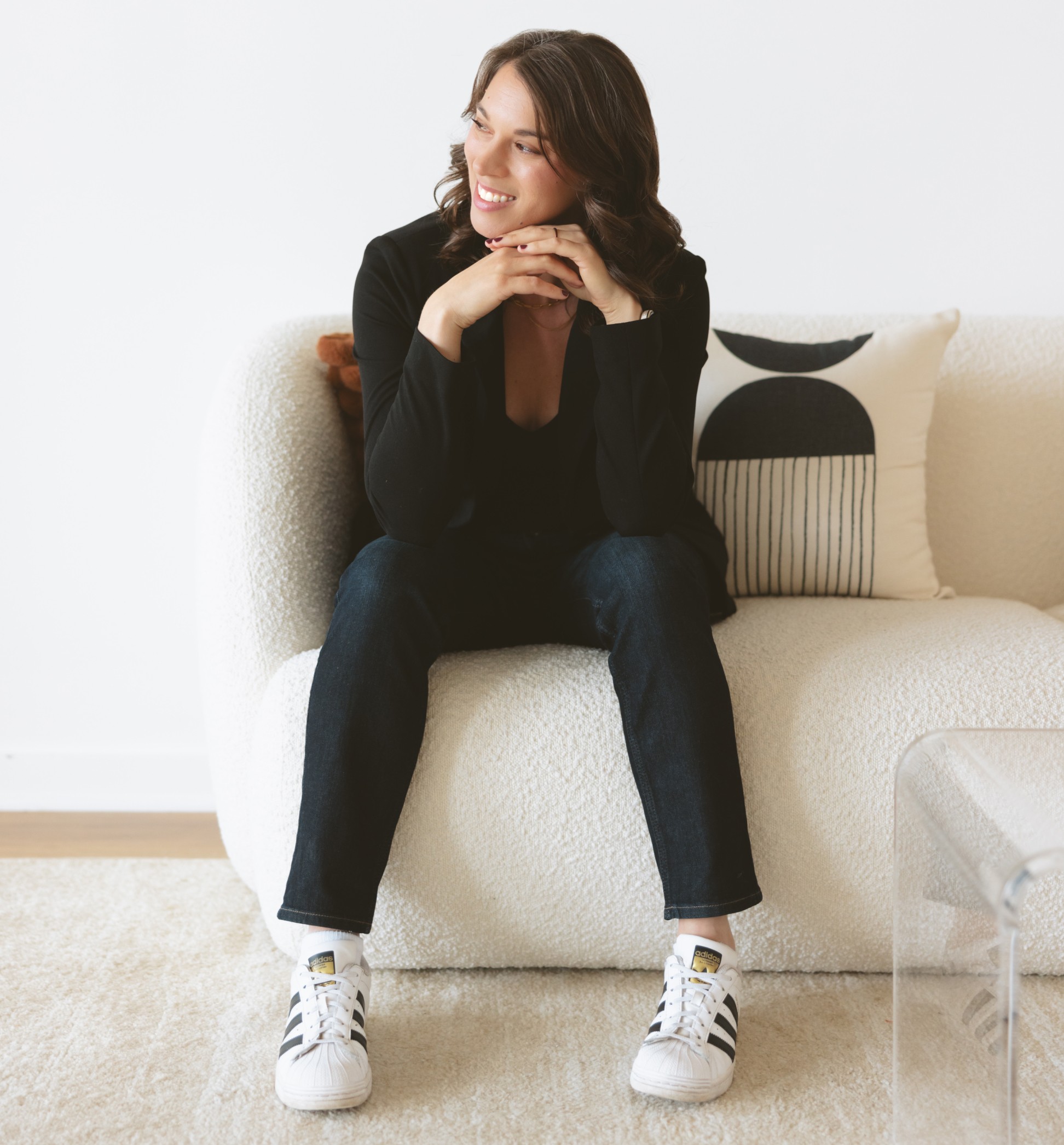 Image of Christine Sitting on a Couch Smiling