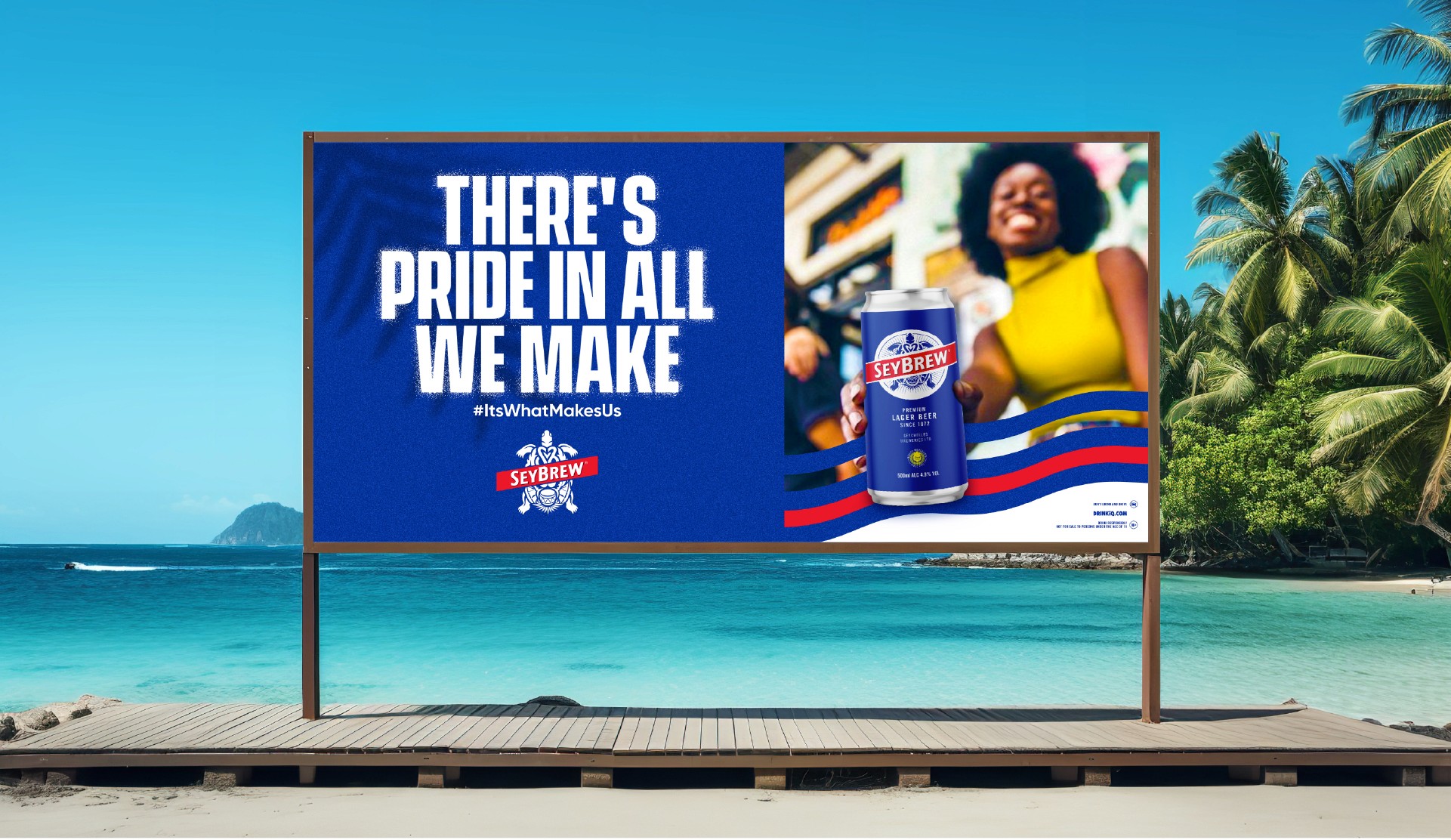 Brick waterfront building with large glass windows, reflecting the warm glow of a sunset over the river.