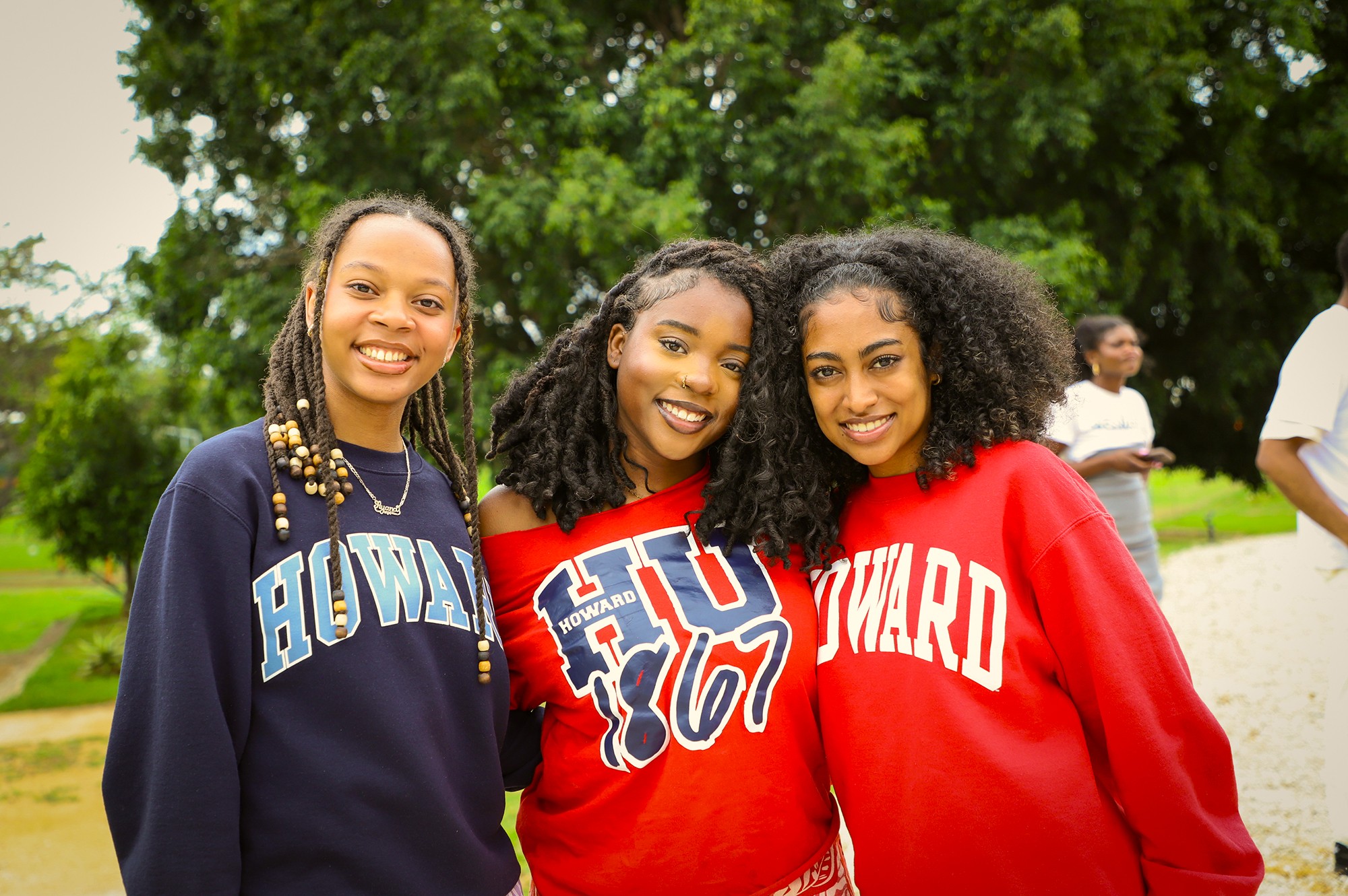 Group shot of 3 female students wearing Howard University sweaters.