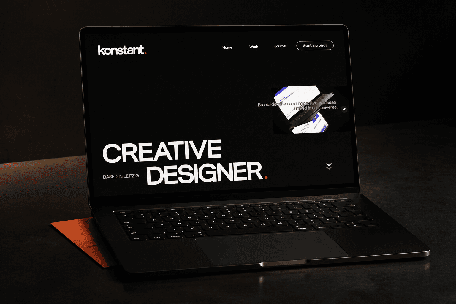 Premium black laptop displaying the Konstantin Influence website on screen