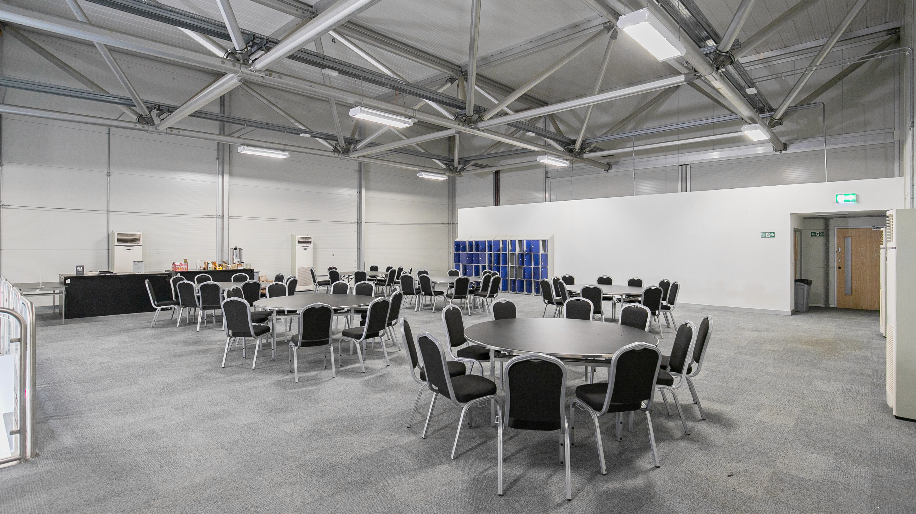 Two classic volkswagen beetles, one green, one cream.