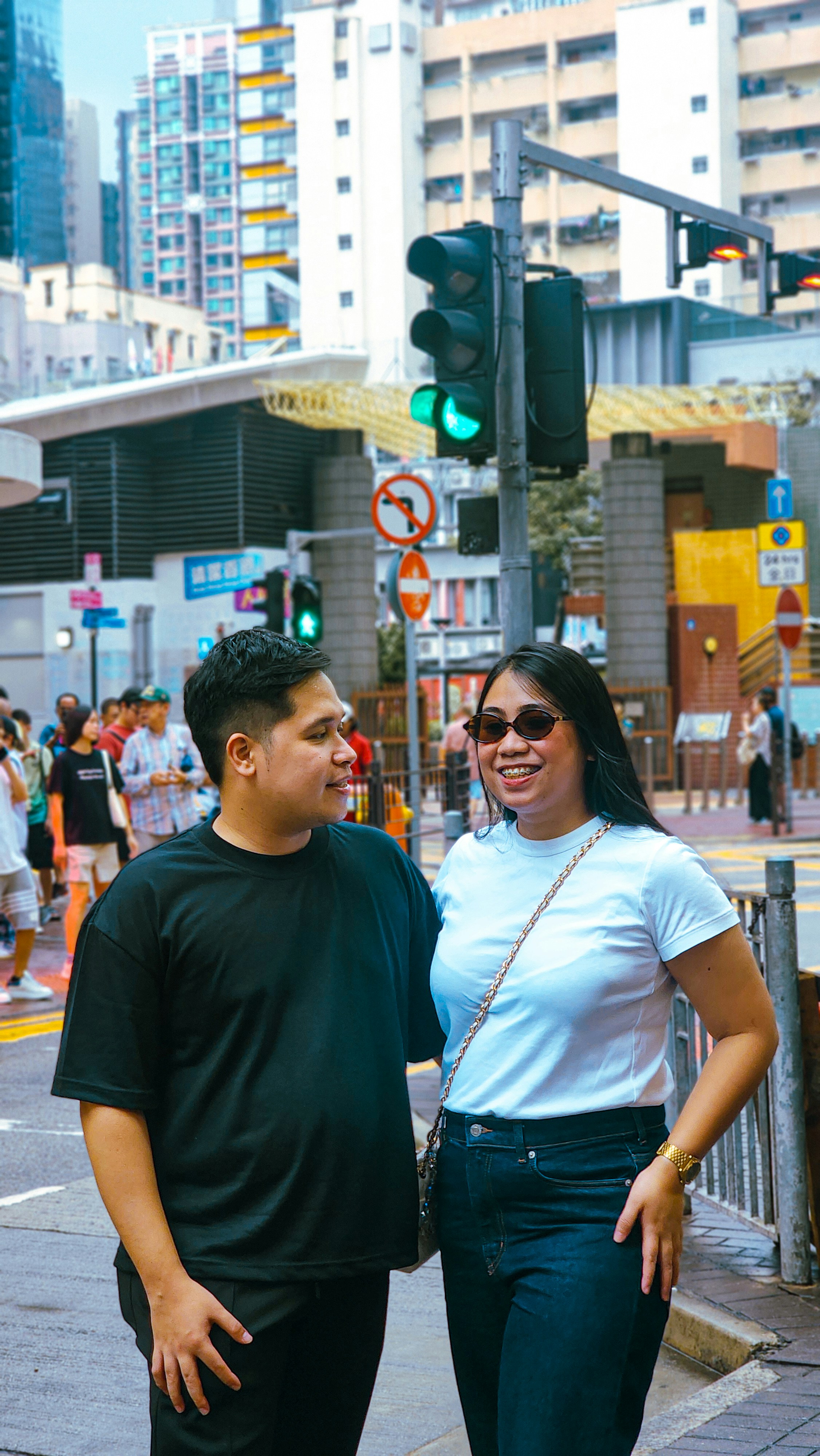 Couple standing on a city street with traffic lights