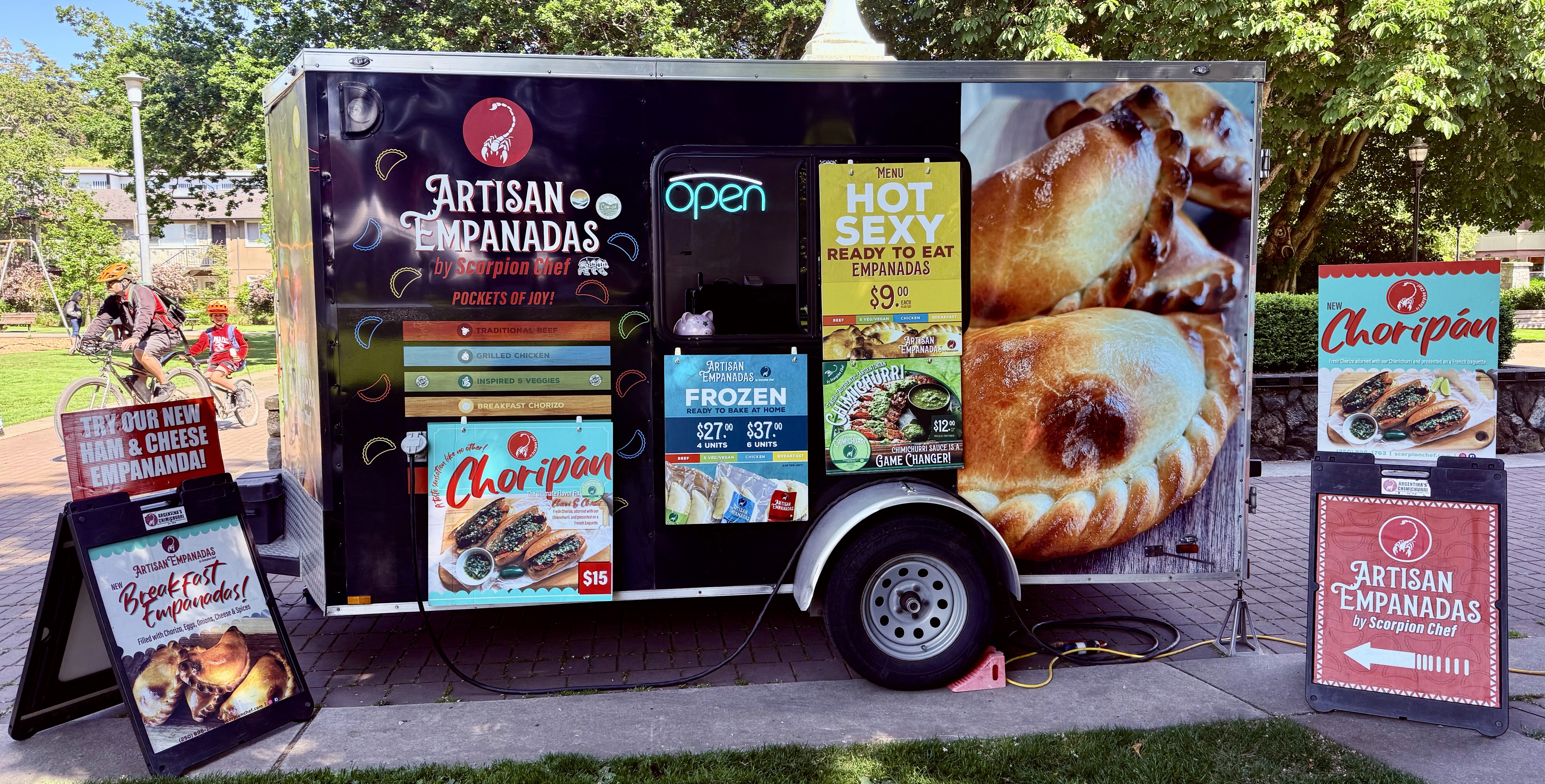 Scorpion Chef artisan empanadas food truck open at a Vancouver Island farmer's market serving hot and frozen empanadas and choripán BC