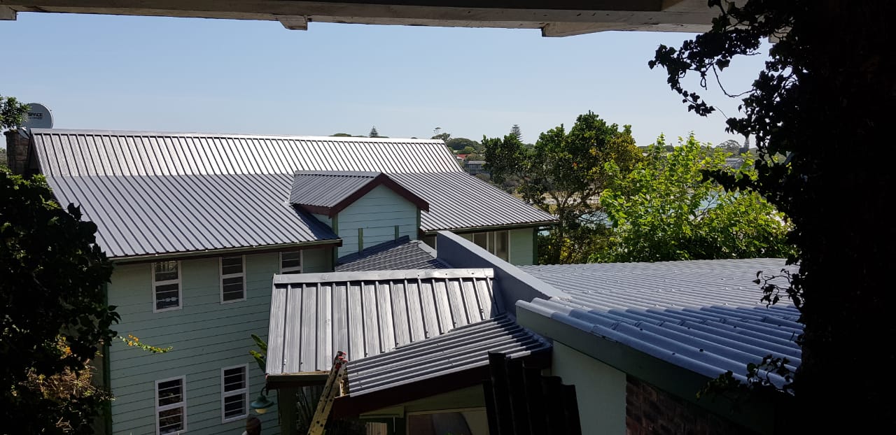 House roof getting sprayed with waterproofiing rubber