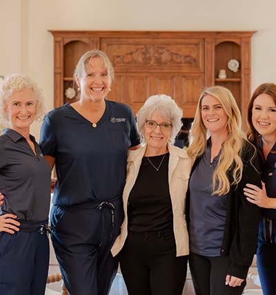 Care team with a client, everyone is smiling