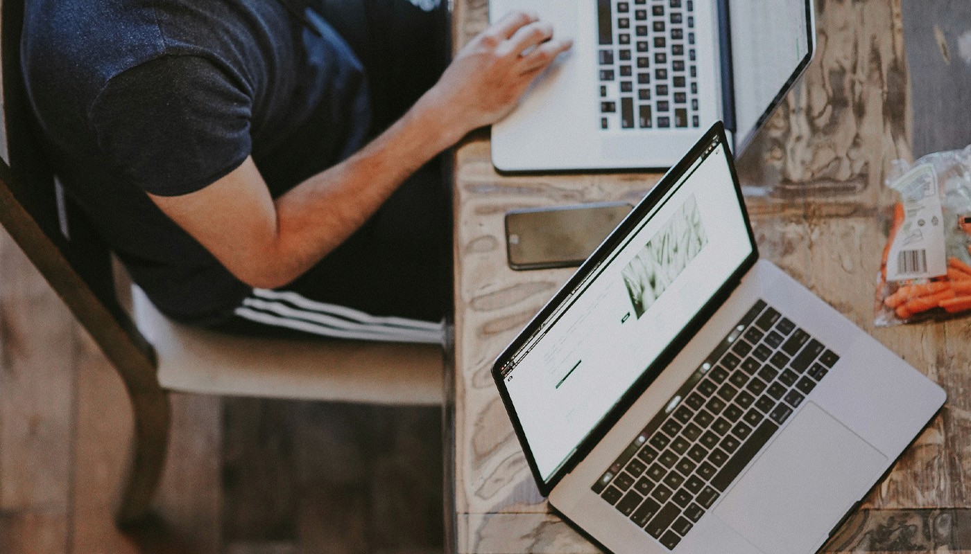 woman sitting around table holding tablet