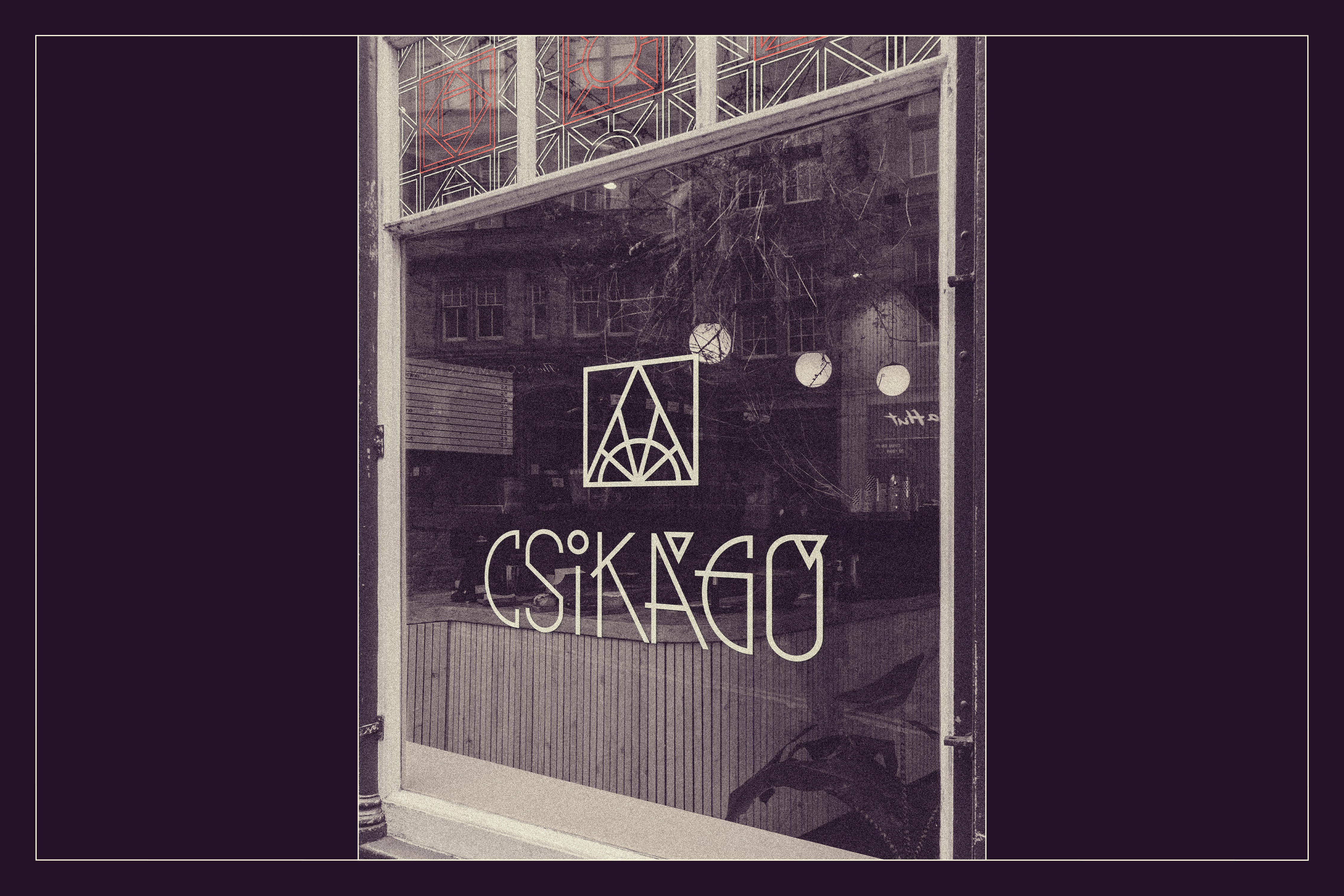 Storefront window mockup featuring the primary vertical logo applied as a white decal - Csikágó, a community space brand identity.