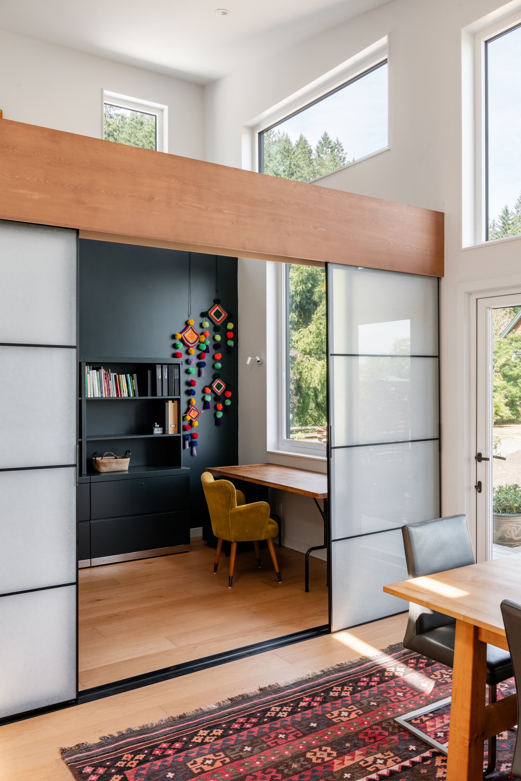 Modern bathroom featuring a walk-in shower, wooden vanity, round mirror, and elegant marble tiles.
