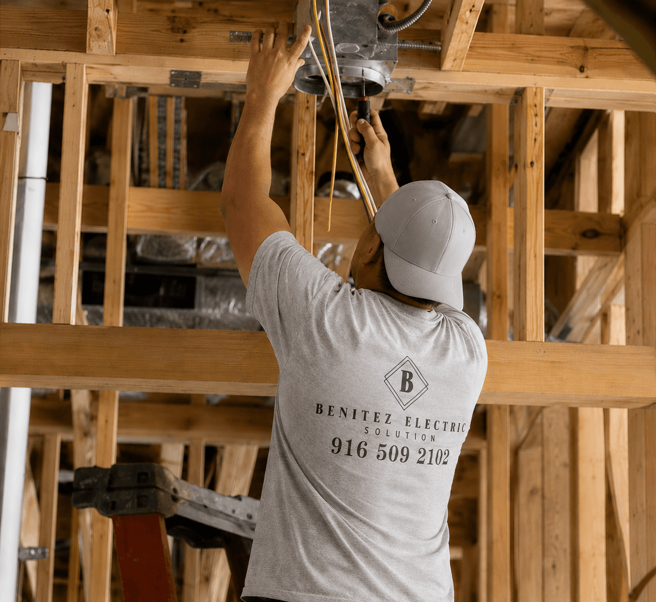 Electrician using digital multimeter to test electrical control panel during safety inspection