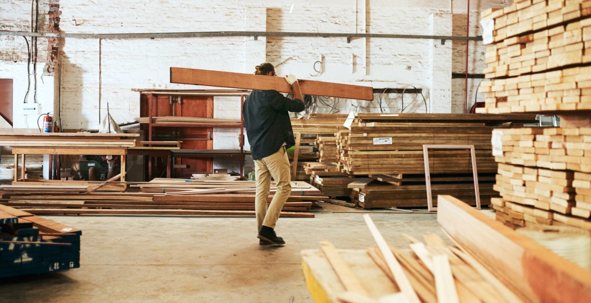 brown and white concrete house near green trees during daytime