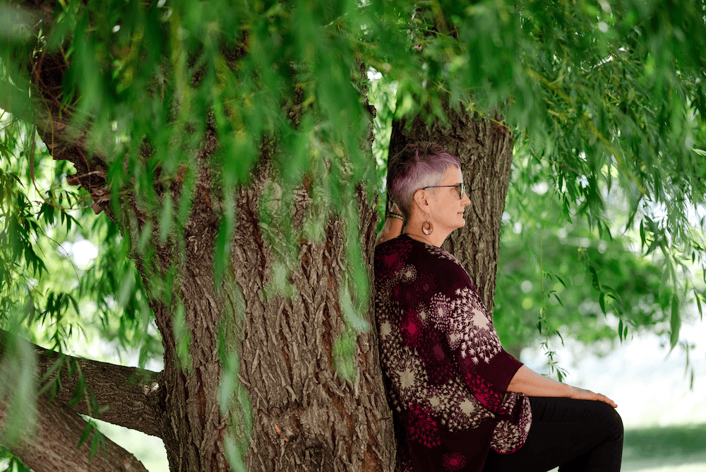 Chris pondering life while sitting in a tree