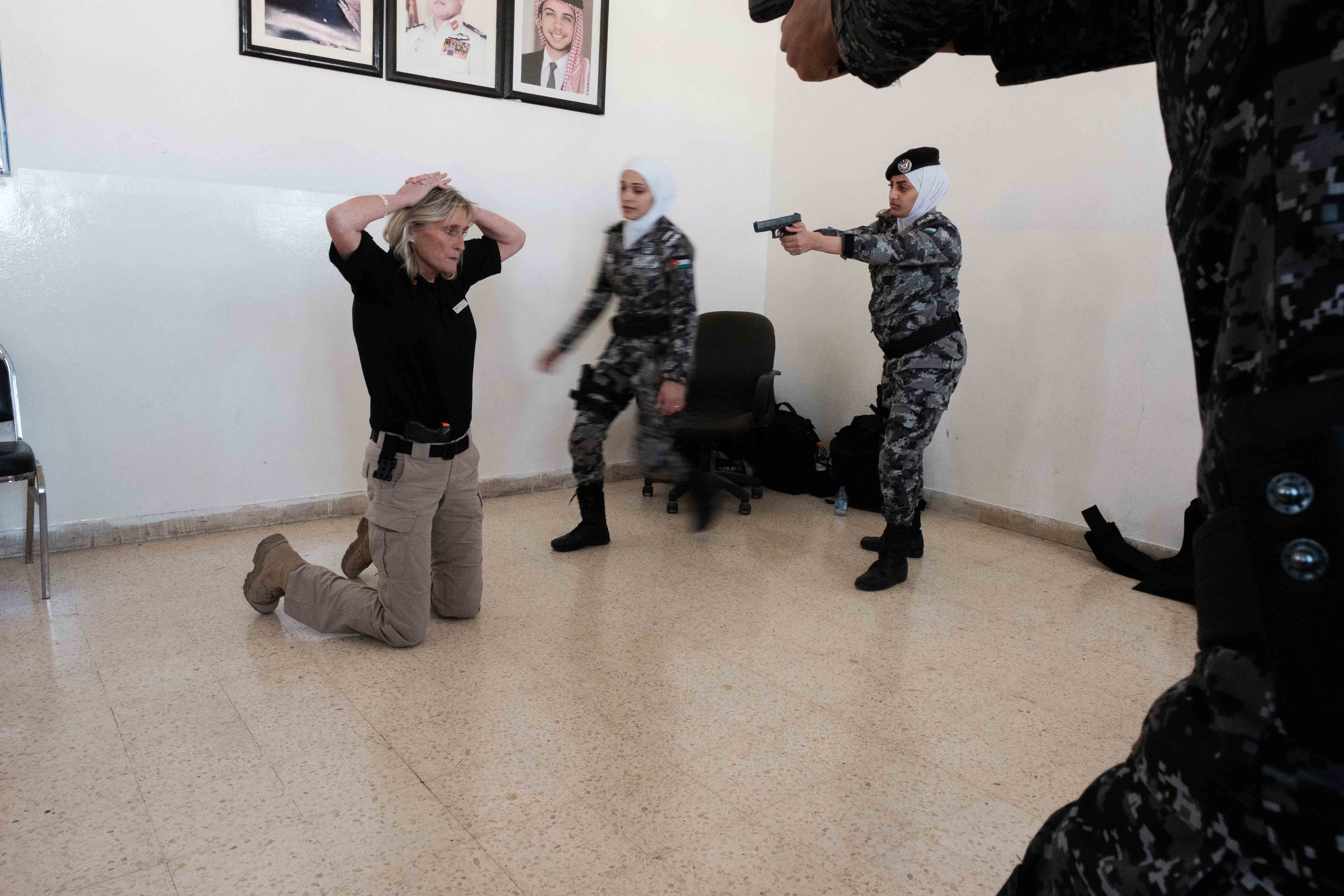 Women police practice searching a building