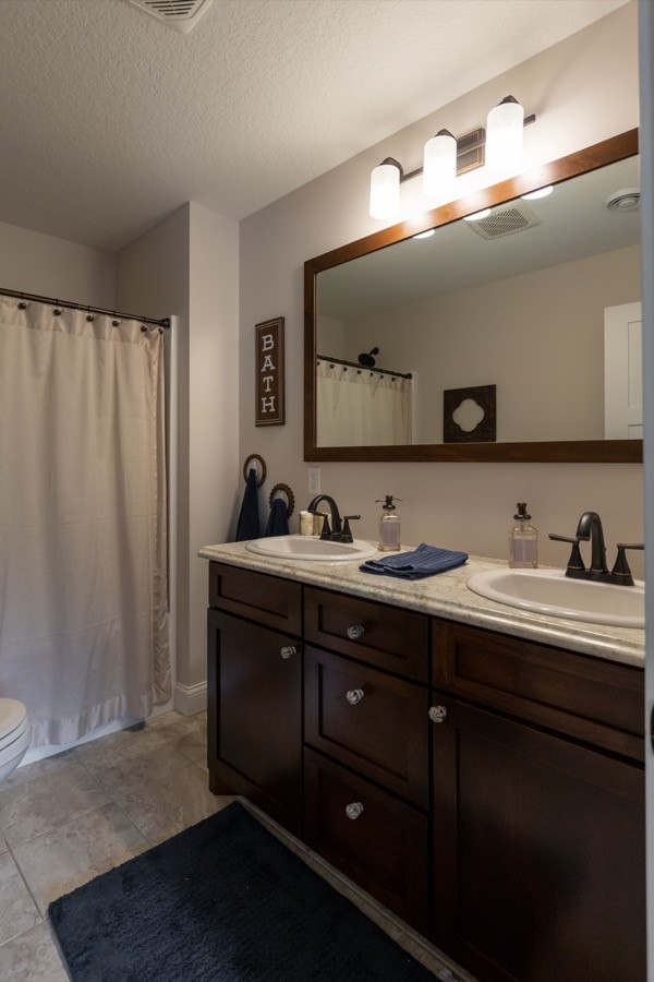 Bathroom with dark cabinets light countertops