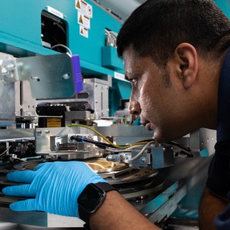 Photo of a Man looking at machine