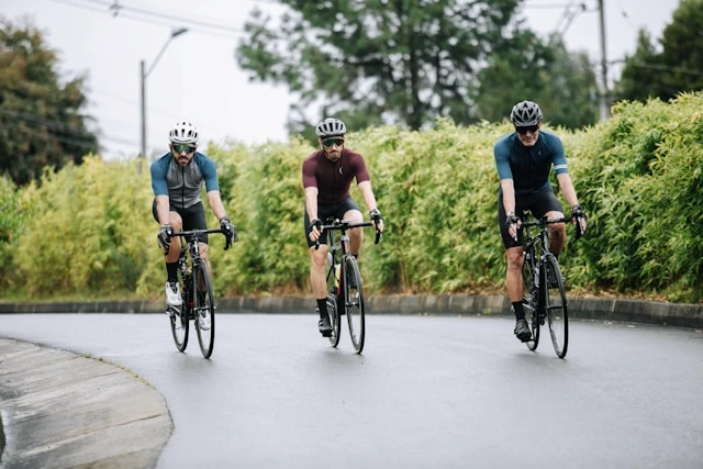 Group of cyclists riding together on a road during an outdoor training session