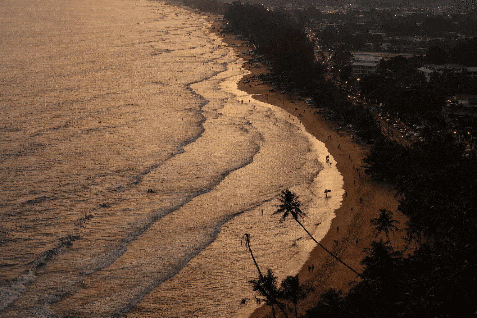 Rolling green hills meet the blue ocean under cloudy sky