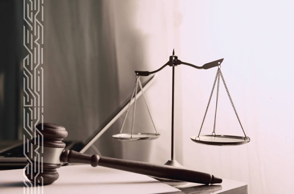 two people sitting at a table with laptops