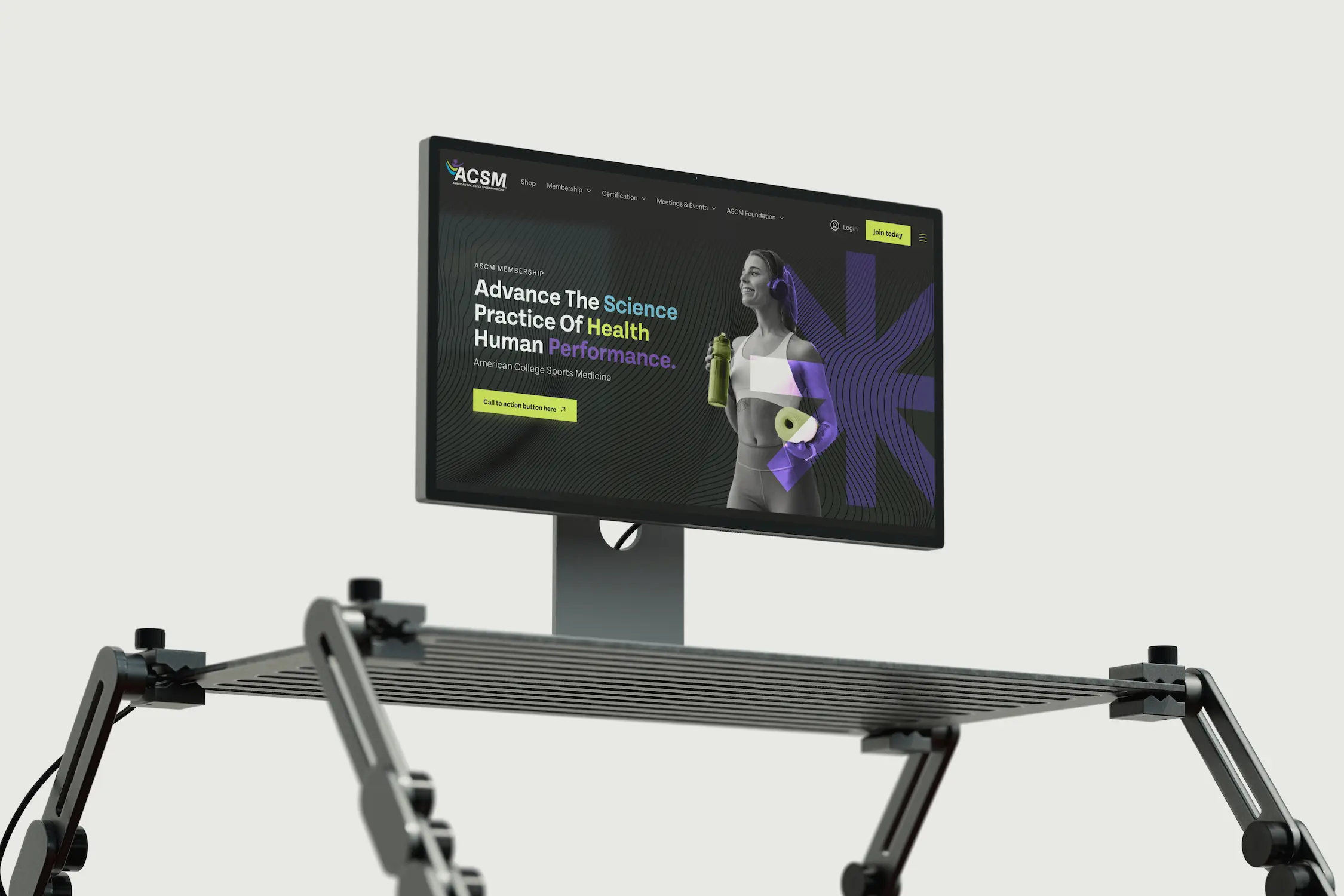 A monitor on a height-adjustable stand displays a digital interface with a character design on the screen.