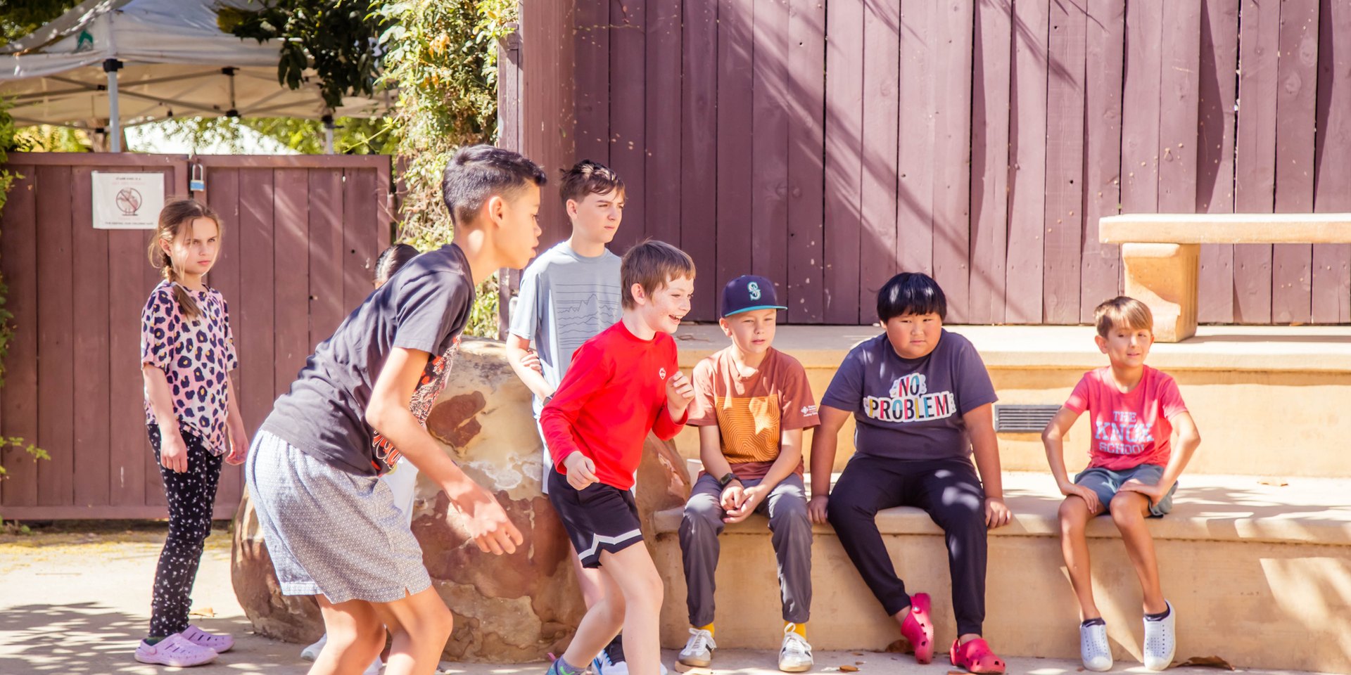 Group of Upper School students gathered on the steps of the outdoor amphitheater