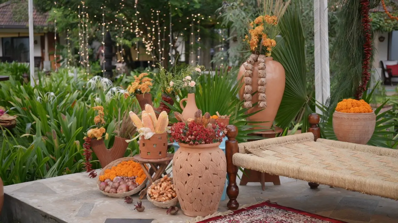 Traditional wedding decor setup at Vedic Village Alleppey with terracotta pots, marigold garlands, fresh produce and fairy lights strung through the garden