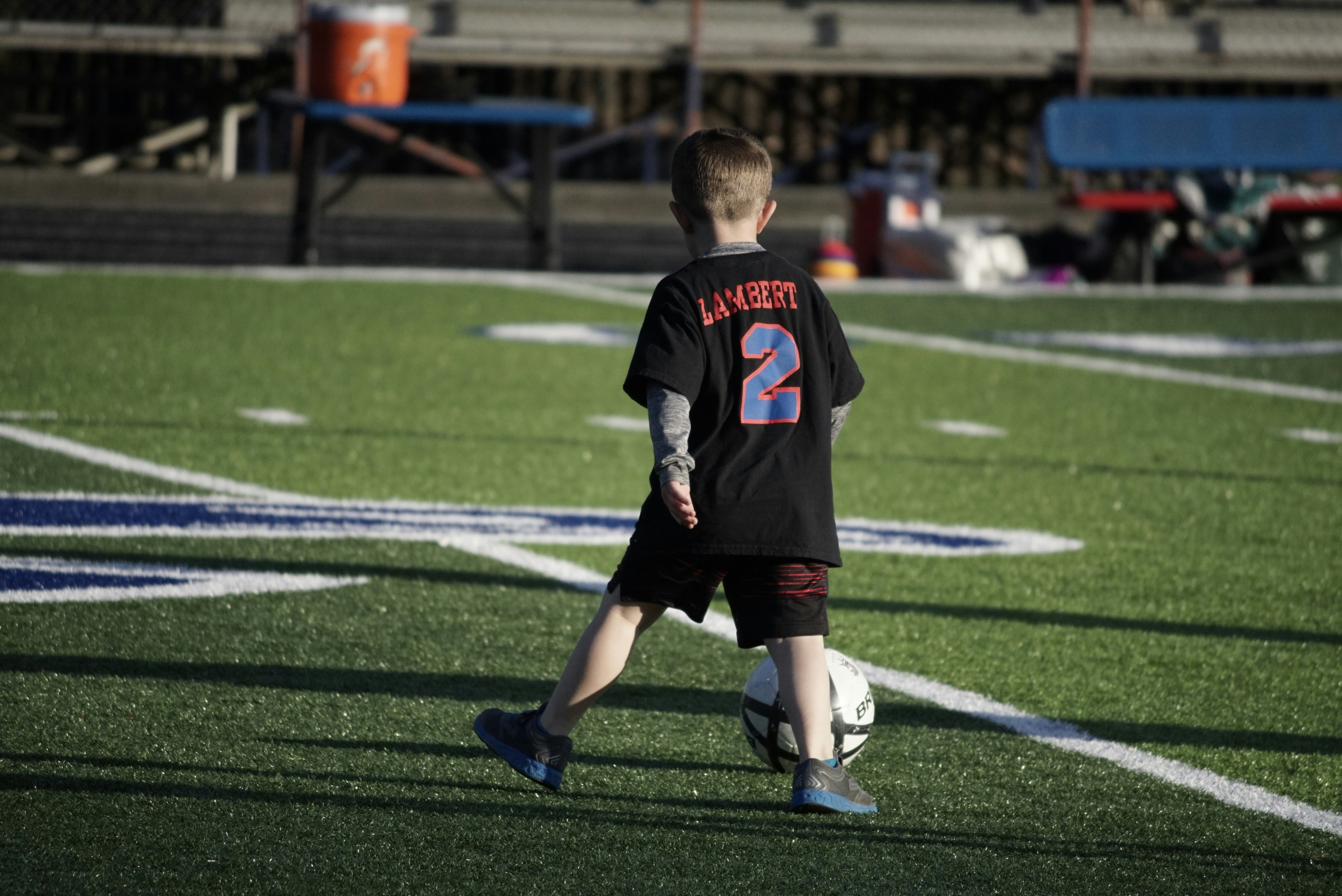 Young boy playing soccer on a field