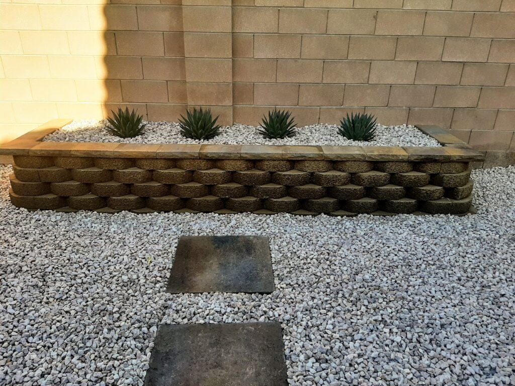 FreshStart Landscaping Vegas desert front yard with rock ground cover drought‑tolerant plants and boulders