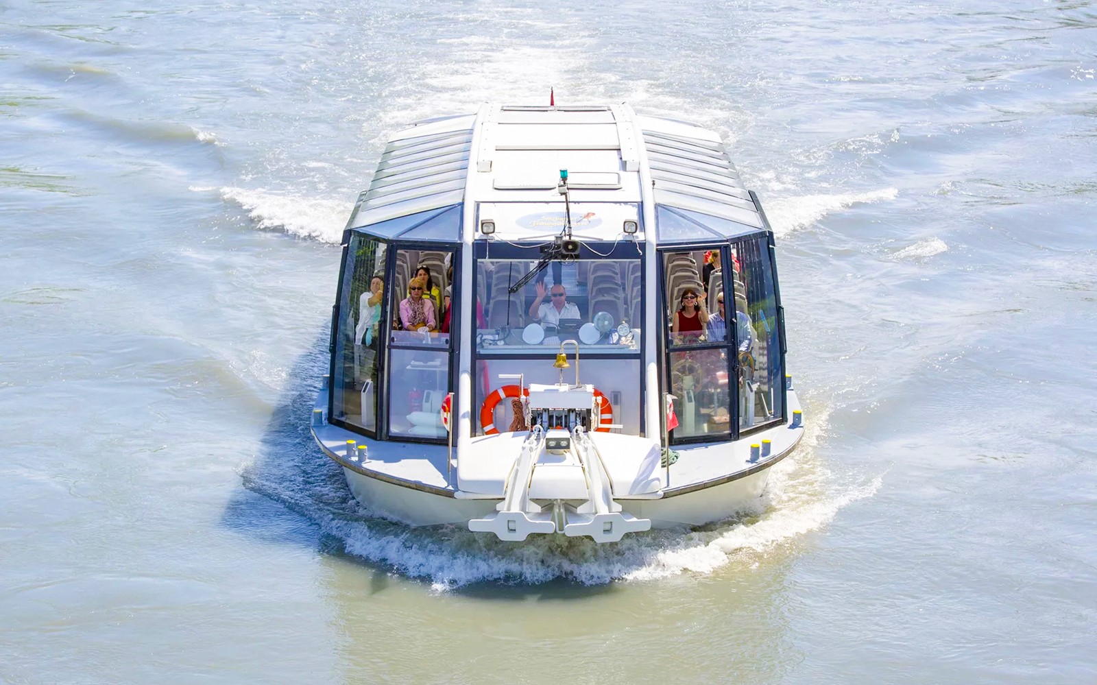 Salzburg river cruise boat with passengers on a scenic tour.