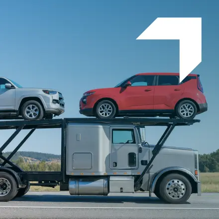 White car hauler with cars representing Car Hauler Insurance services by GIA Group, LLC