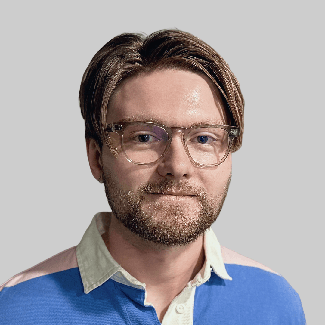 Profile portrait of a man in a white shirt against a light background