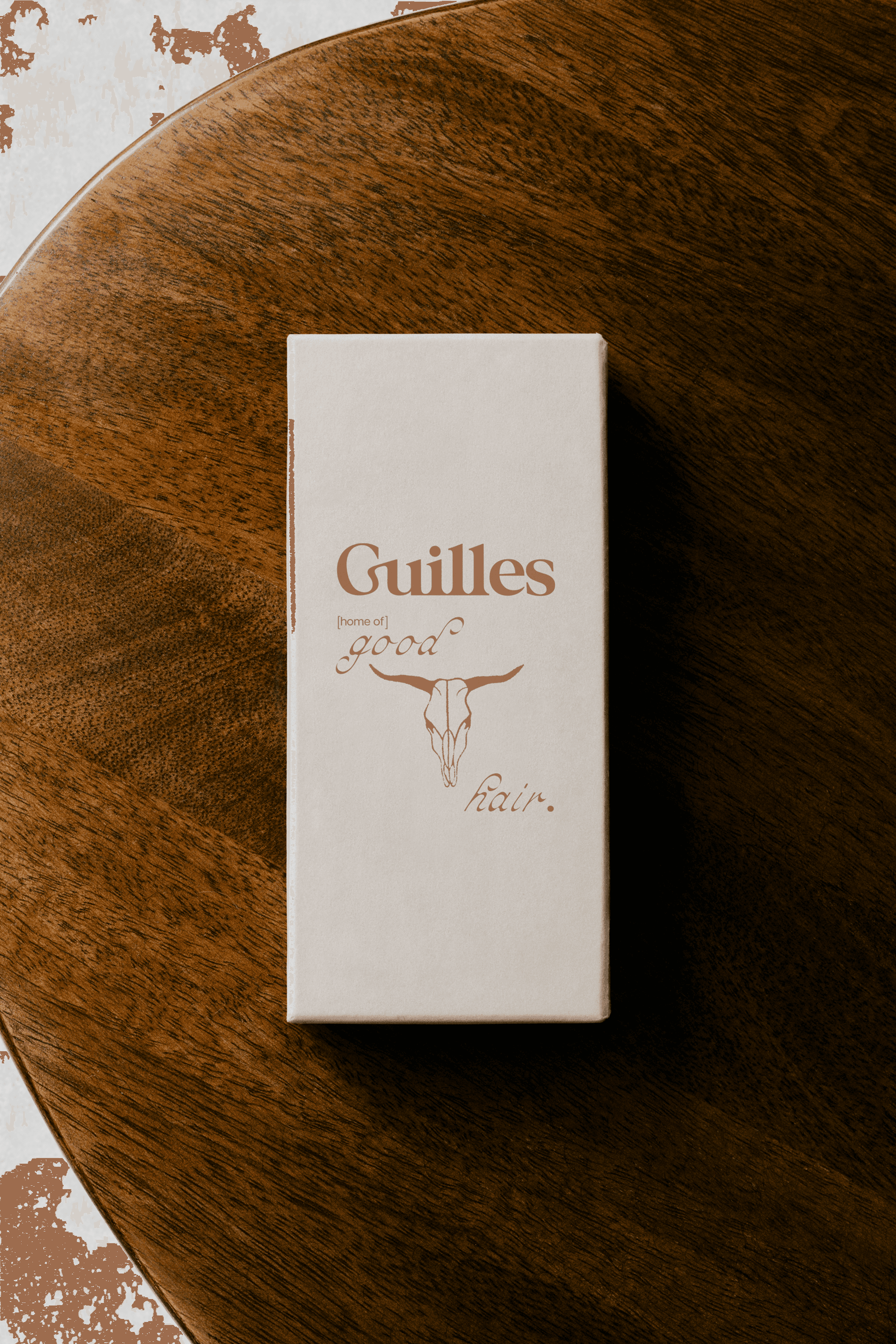Branding image for a luxury hair salon named Guilles based in Sydney, featuring sleek packaging and print.