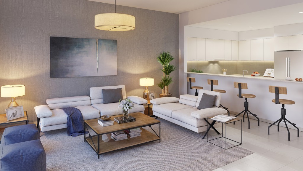  A modern living room featuring white furniture and an open kitchen in Sidra Villas.