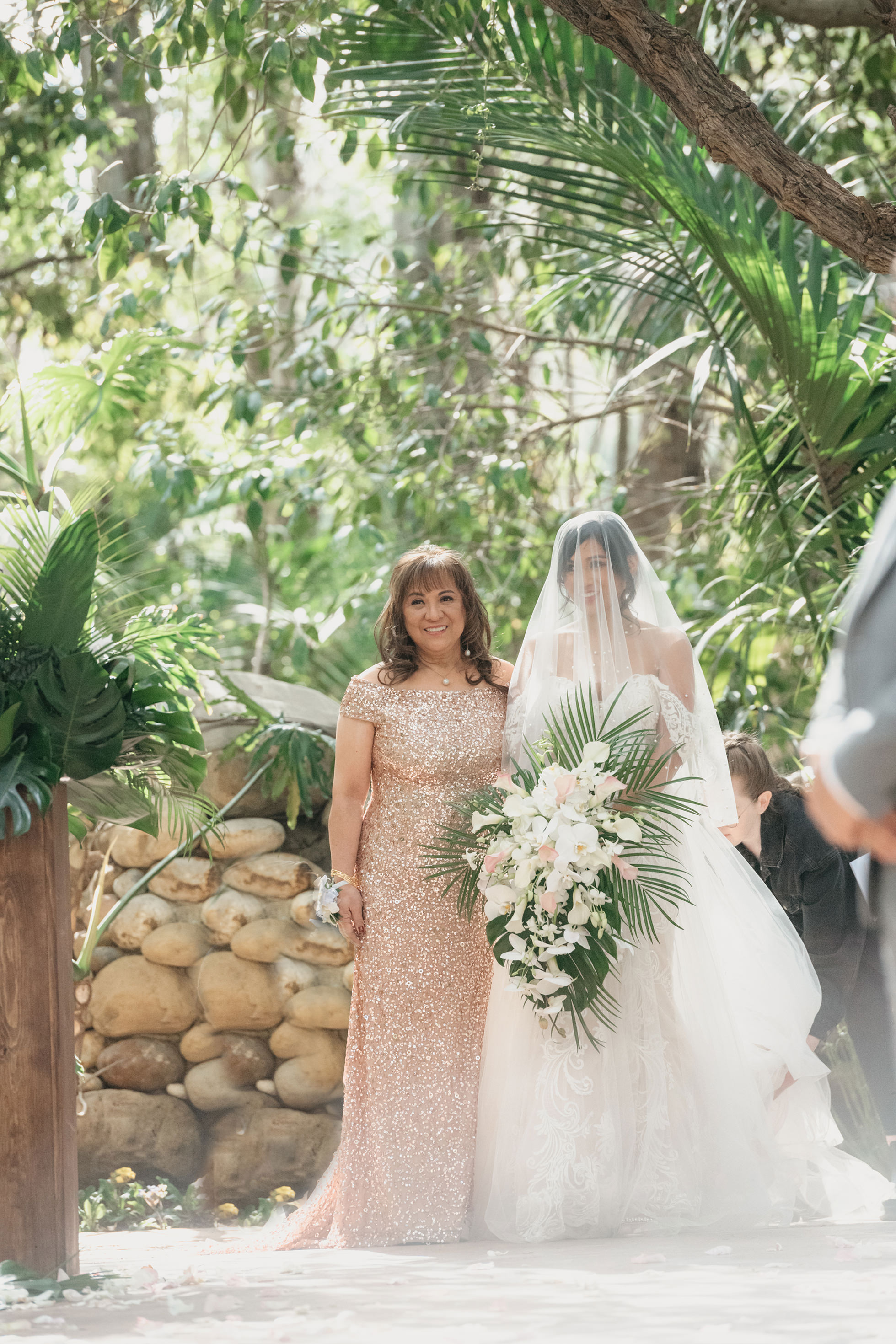 Bride walking down the aisle at outdoor garden ceremony