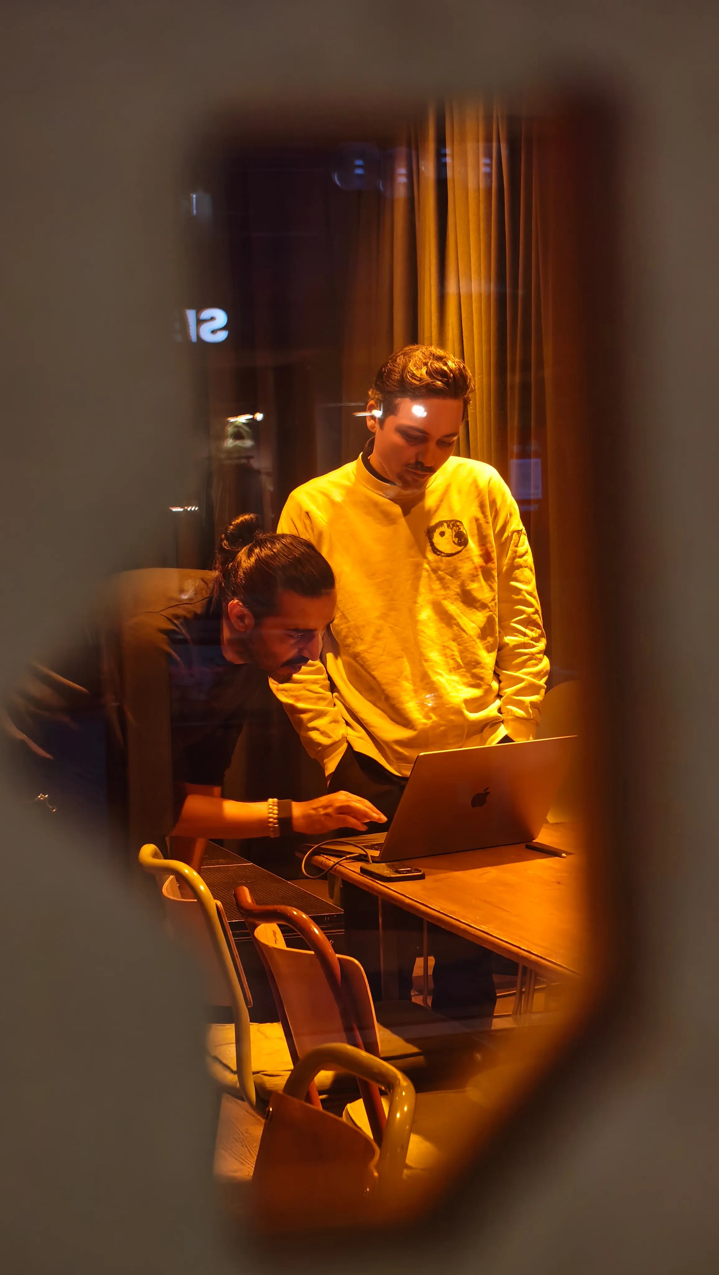 Two persons working on a laptop