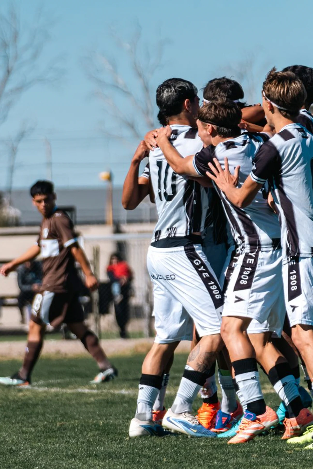Soccer players celebrating in a team huddle