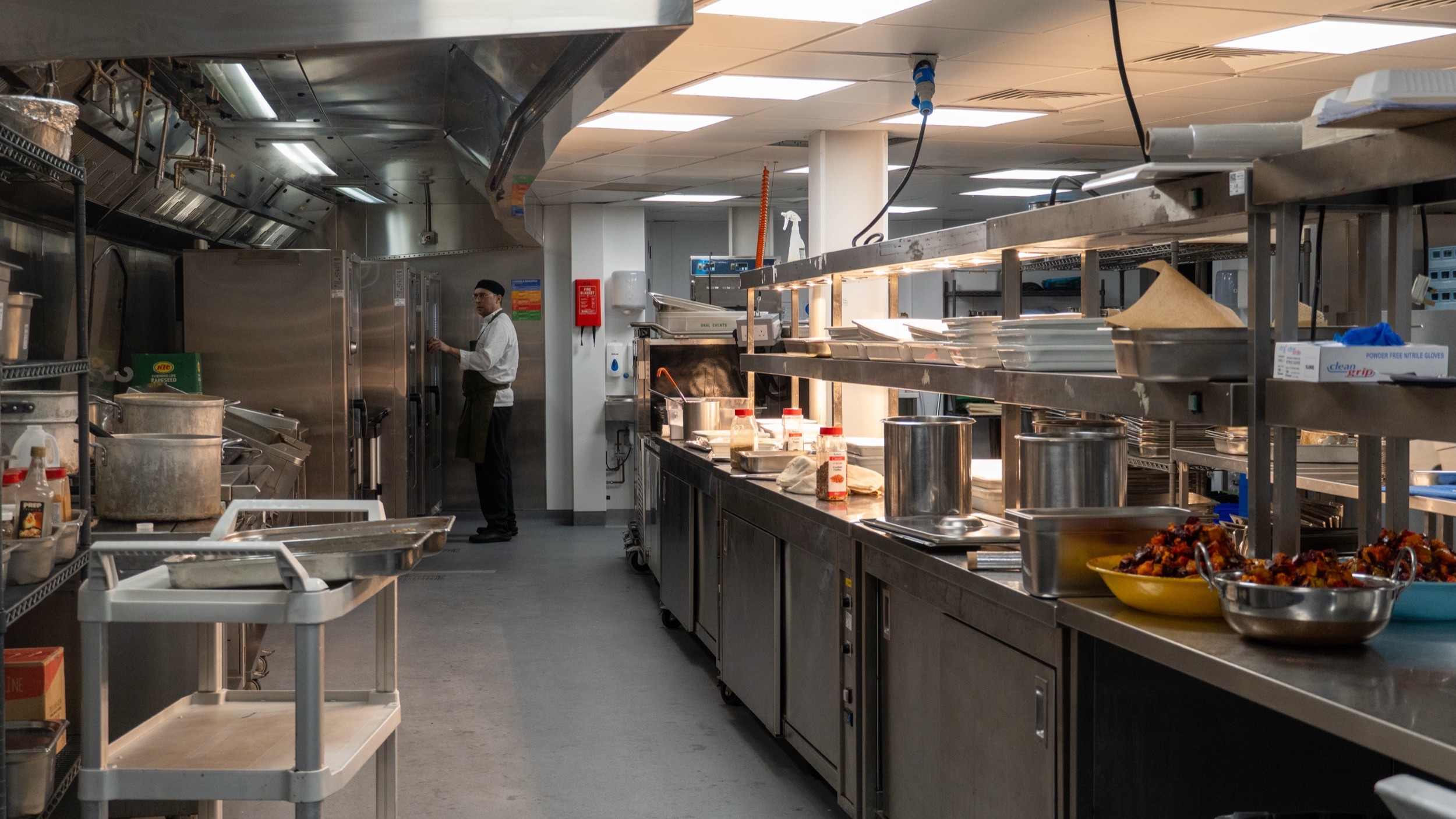 Two classic volkswagen beetles, one green, one cream.