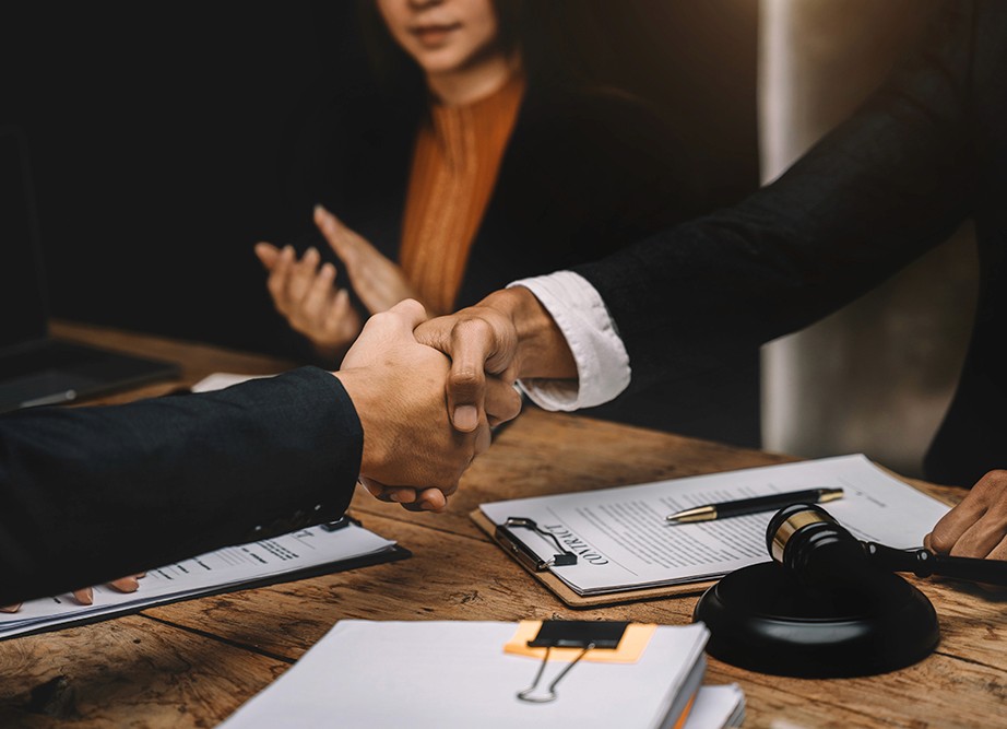 man standing in front of people sitting beside table with laptop computers